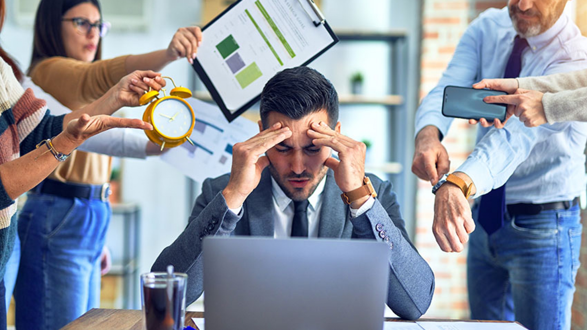 Group of business workers working together. Partners stressing one of them at the office